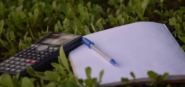 blue ballpoint pen on paper beside calculator by Ashraf Ali courtesy of Unsplash.